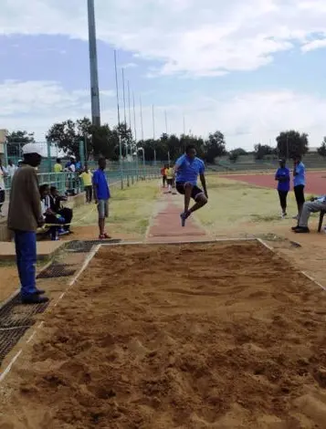 Student athlete performing long jump